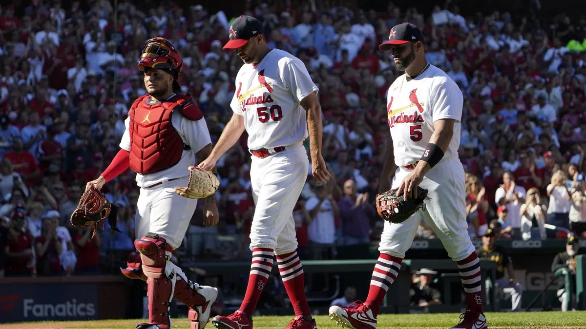 Adam Wainwright, Yadier Molina, and Albert Pujols walk off Busch field in St. Louis in one of their final home games together. (Courtesy of AP Photo - Jeff Robertson)